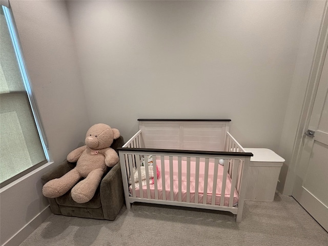 2409 Webster St, Houston, TX 77003 - carpeted bedroom featuring a crib and baseboards