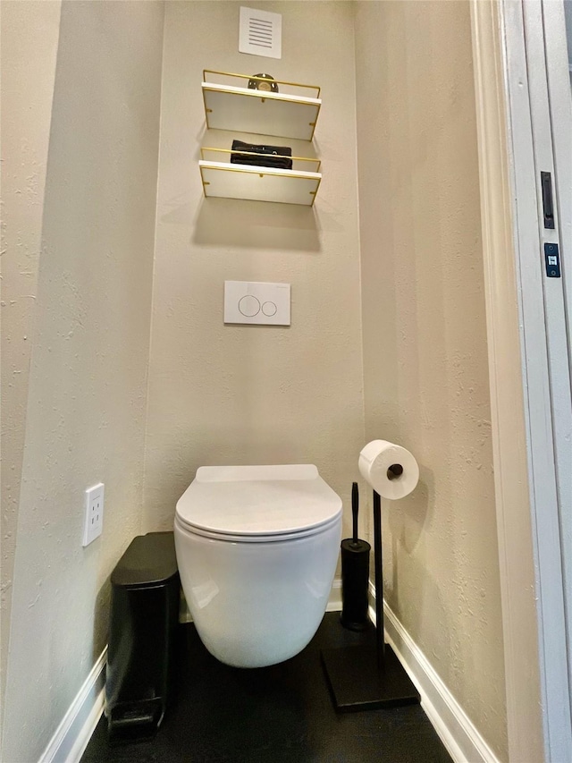 bathroom featuring visible vents, toilet, and baseboards