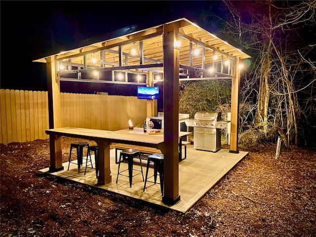 view of patio / terrace featuring fence, outdoor dining space, and area for grilling