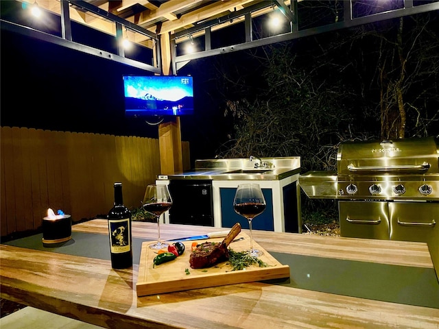 view of patio with a sink and area for grilling