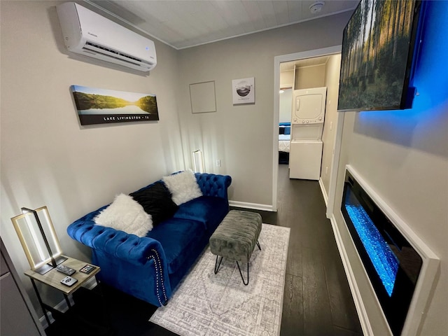 living room featuring dark wood-type flooring, stacked washer and clothes dryer, and a wall mounted AC