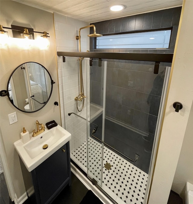 bathroom with recessed lighting, a shower stall, and vanity