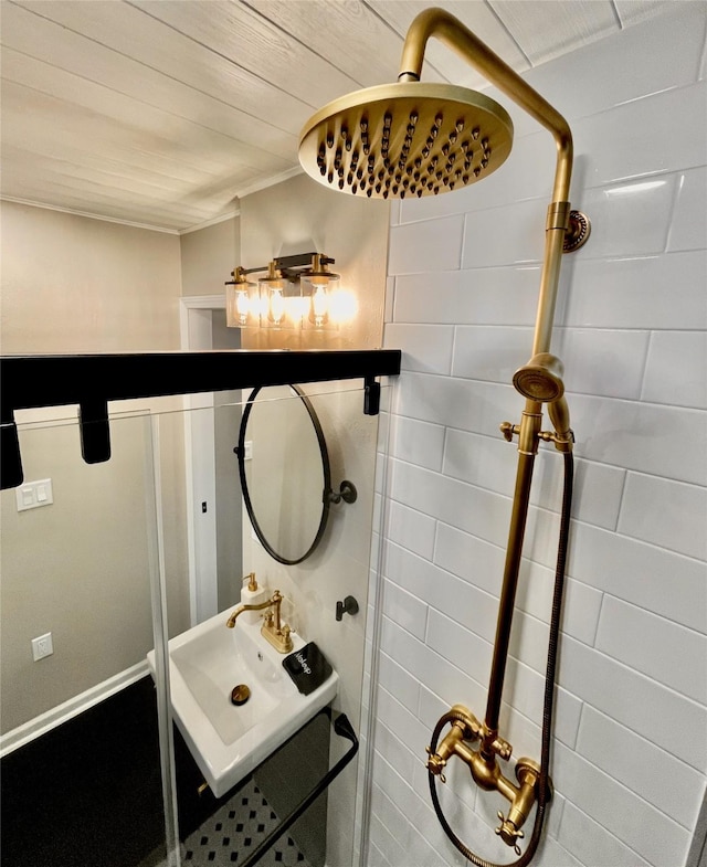 bathroom with a sink and tiled shower