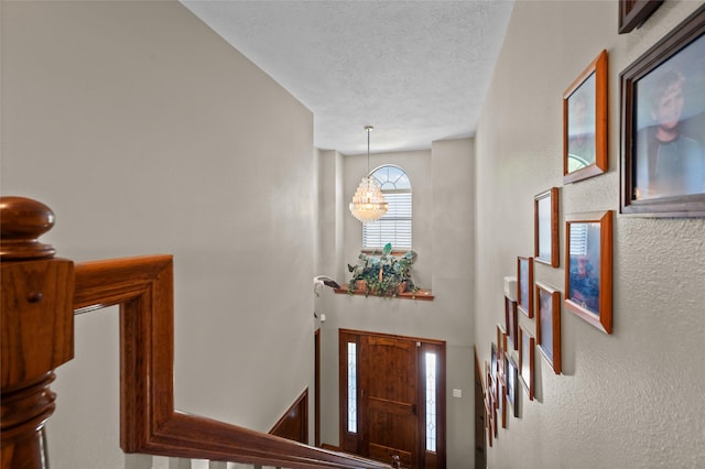 5922 Redfish Run, Baytown, TX 77523 - entrance foyer featuring an inviting chandelier and a textured ceiling