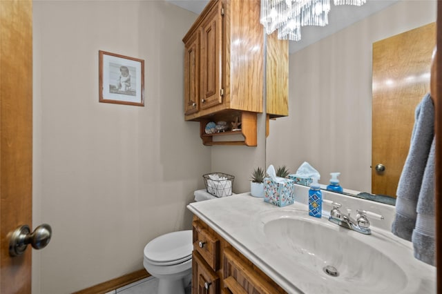 5922 Redfish Run, Baytown, TX 77523 - bathroom featuring toilet, an inviting chandelier, and vanity