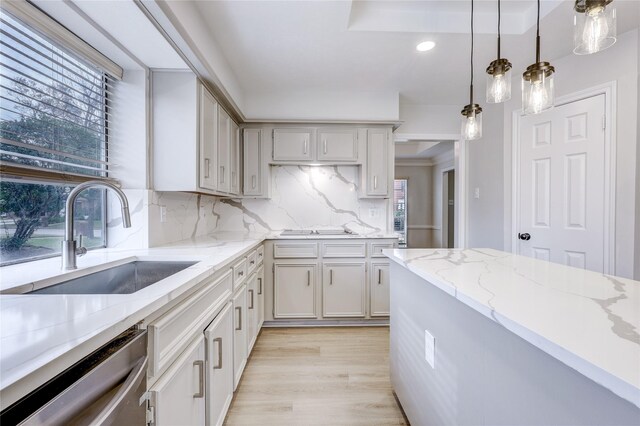 kitchen featuring a sink, decorative light fixtures, recessed lighting, dishwasher, and backsplash