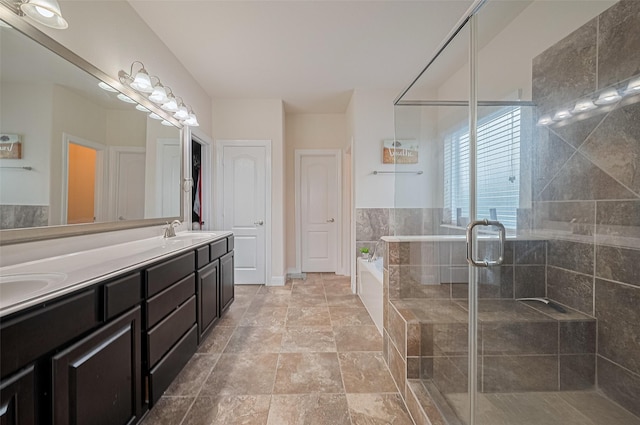 20322 Fossil Valley Ln, Cypress, TX 77433 - full bathroom featuring a garden tub, double vanity, a shower stall, and stone finish flooring