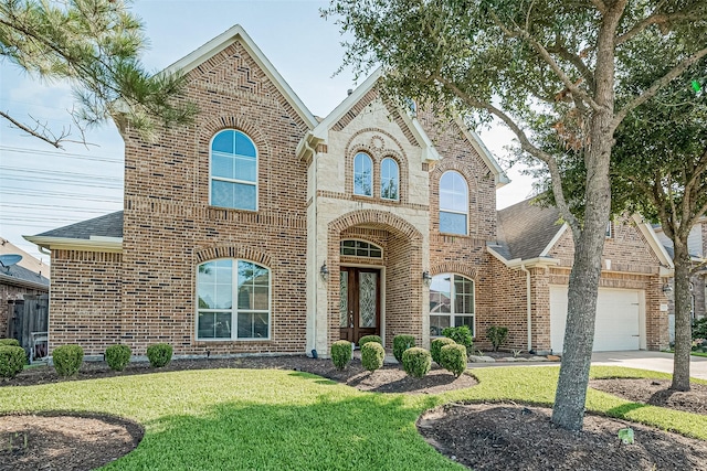 20322 Fossil Valley Ln, Cypress, TX 77433 - french country home with brick siding, an attached garage, a front yard, and a shingled roof