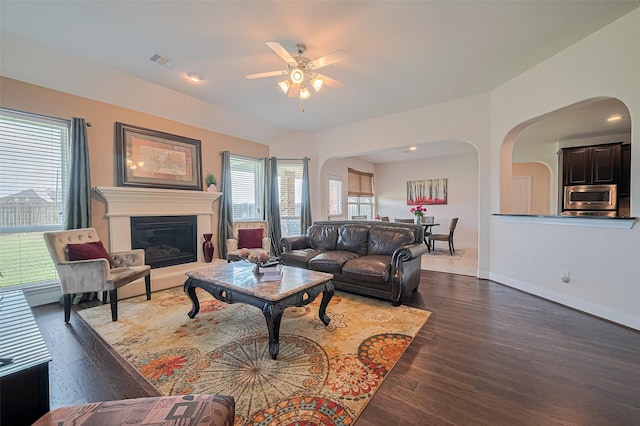 20322 Fossil Valley Ln, Cypress, TX 77433 - living room featuring arched walkways, a ceiling fan, wood finished floors, and healthy amount of natural light