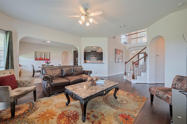 20322 Fossil Valley Ln, Cypress, TX 77433 - living area with arched walkways, a ceiling fan, wood finished floors, and stairway