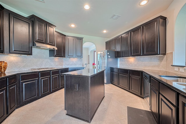 20322 Fossil Valley Ln, Cypress, TX 77433 - kitchen with arched walkways, a kitchen island, recessed lighting, decorative backsplash, and stainless steel appliances
