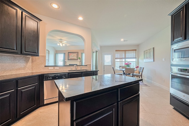 20322 Fossil Valley Ln, Cypress, TX 77433 - kitchen featuring appliances with stainless steel finishes, a center island, recessed lighting, backsplash, and a ceiling fan