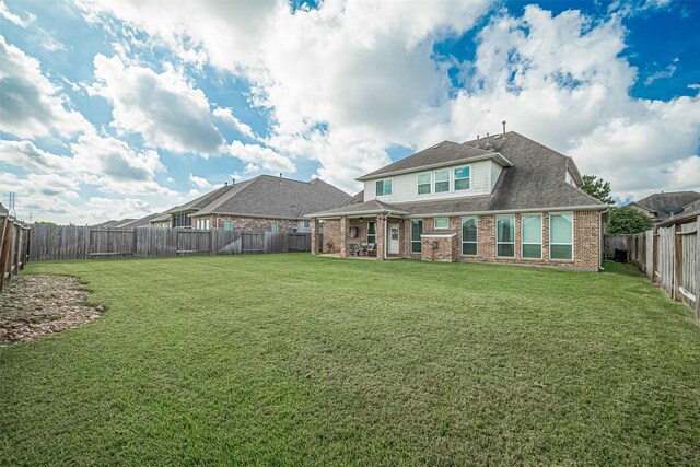 20322 Fossil Valley Ln, Cypress, TX 77433 - rear view of house featuring brick siding, a fenced backyard, a patio area, and roof with shingles