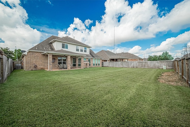 20322 Fossil Valley Ln, Cypress, TX 77433 - back of property featuring brick siding, a patio area, a fenced backyard, and roof with shingles