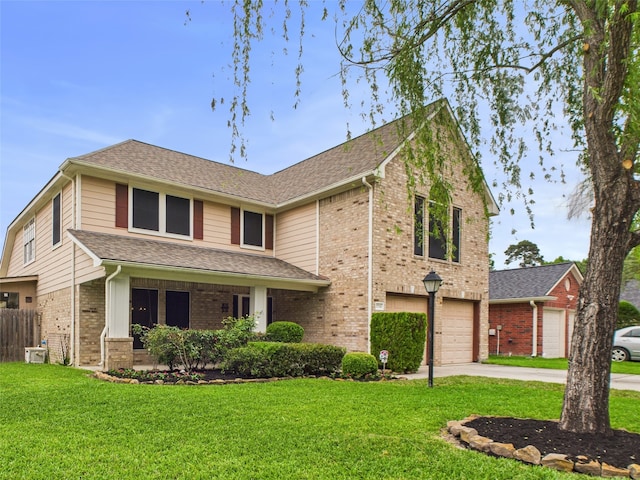 traditional-style house with concrete driveway, brick siding, a front yard, and a garage
