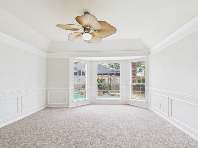 spare room featuring vaulted ceiling, carpet flooring, and a ceiling fan