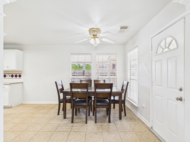 dining room with visible vents, a ceiling fan, a wealth of natural light, and light tile patterned floors