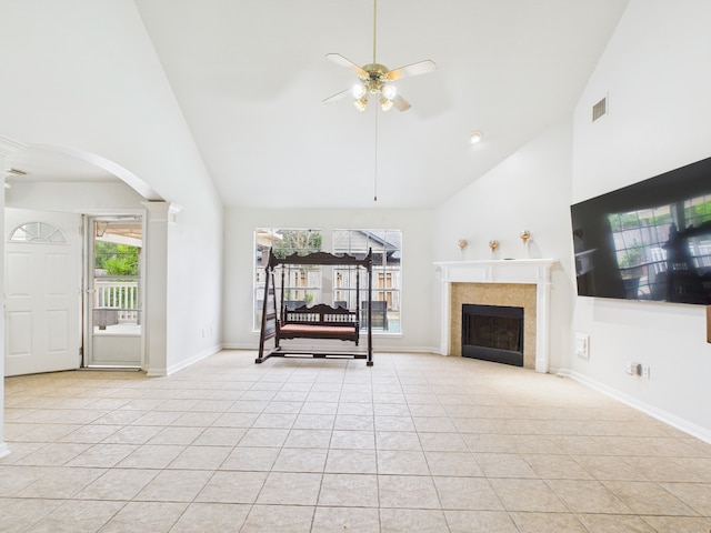 living area featuring high vaulted ceiling, ceiling fan, light tile patterned floors, and decorative columns