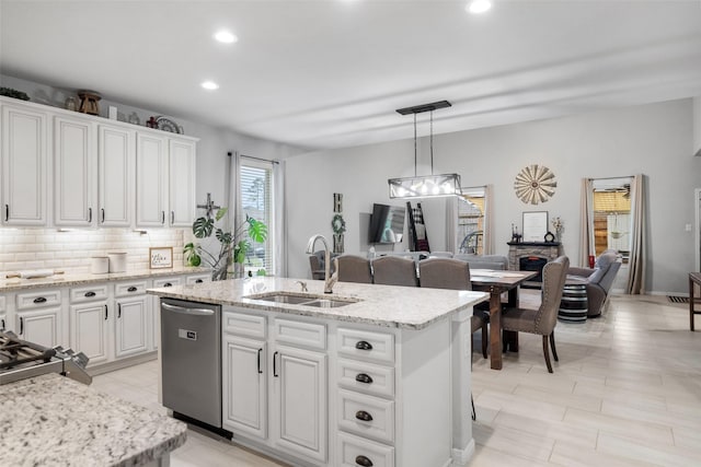 18203 Octavio Frias Trl, Atascocita, TX 77044 - kitchen with a sink, recessed lighting, an island with sink, white cabinetry, and stainless steel dishwasher