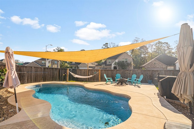 18203 Octavio Frias Trl, Atascocita, TX 77044 - view of pool featuring a patio, a fenced in pool, a fenced backyard, and a fire pit