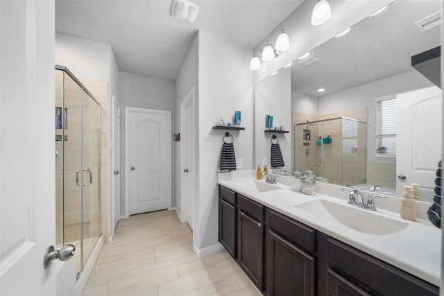 18203 Octavio Frias Trl, Atascocita, TX 77044 - full bath featuring a shower stall, visible vents, double vanity, and a sink