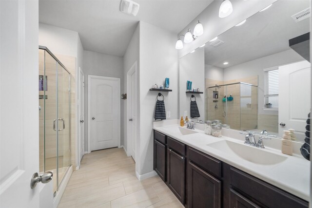 18203 Octavio Frias Trl, Atascocita, TX 77044 - full bathroom with a shower stall, double vanity, tile patterned floors, and baseboards