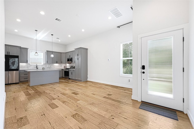 kitchen featuring stainless steel appliances, light countertops, visible vents, and gray cabinets