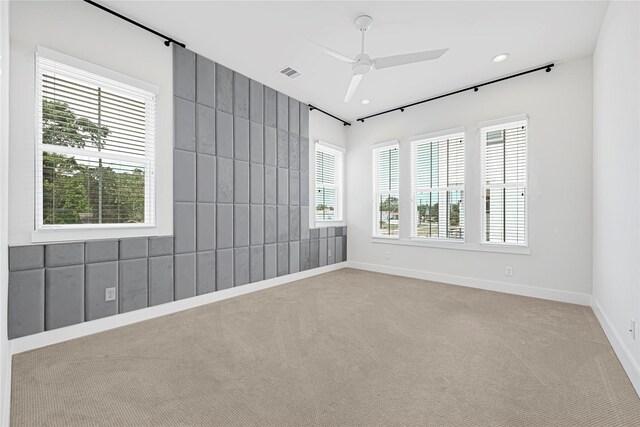 carpeted empty room with baseboards, a ceiling fan, visible vents, and recessed lighting