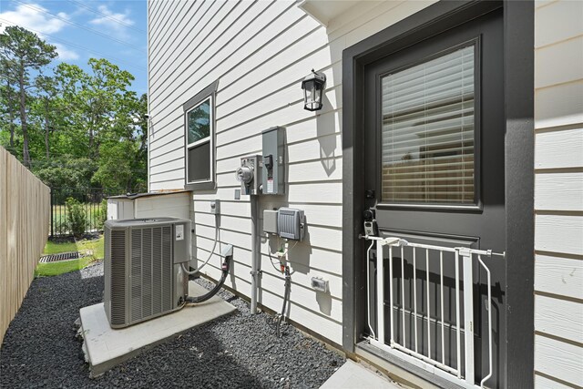 entrance to property with fence and central AC unit