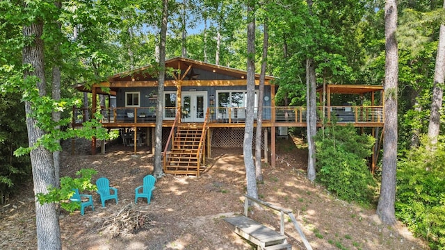 view of play area with a wooden deck, french doors, and stairway