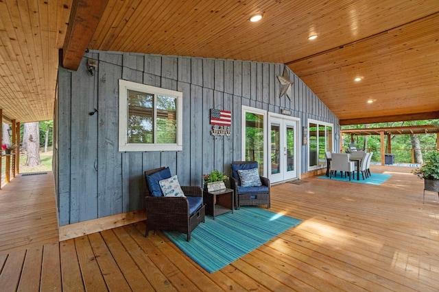 wooden deck featuring outdoor dining area and french doors