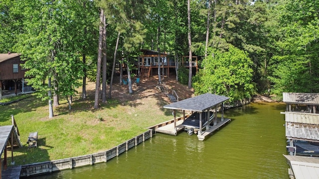 dock area featuring a deck with water view, boat lift, and stairway