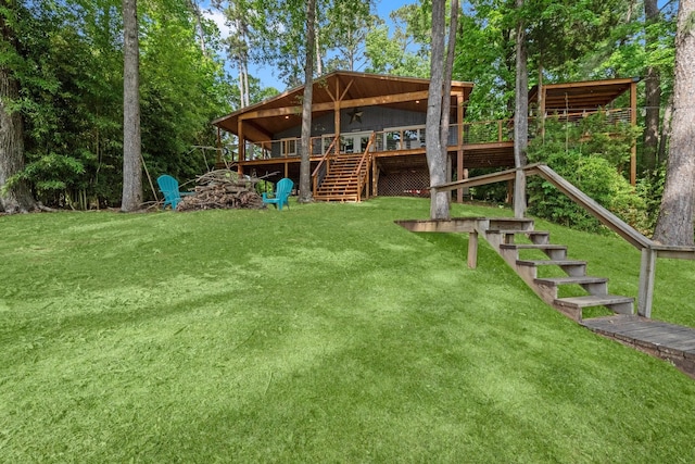 view of yard featuring a wooden deck and stairway