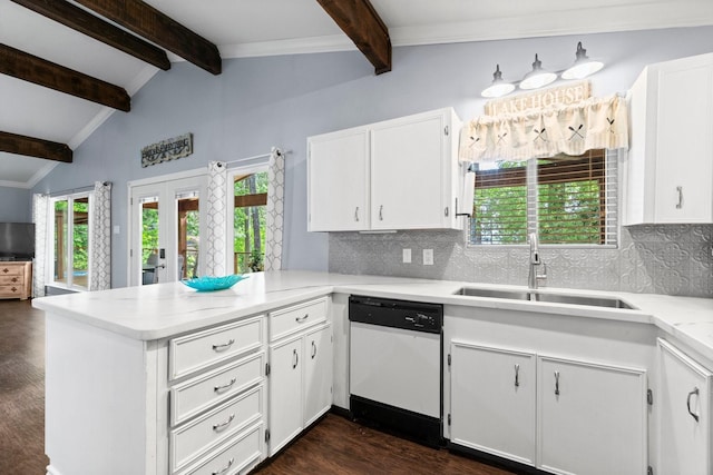 kitchen featuring a peninsula, a sink, tasteful backsplash, white cabinetry, and white dishwasher