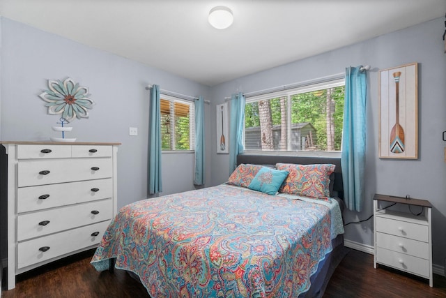 bedroom featuring wood finished floors and baseboards