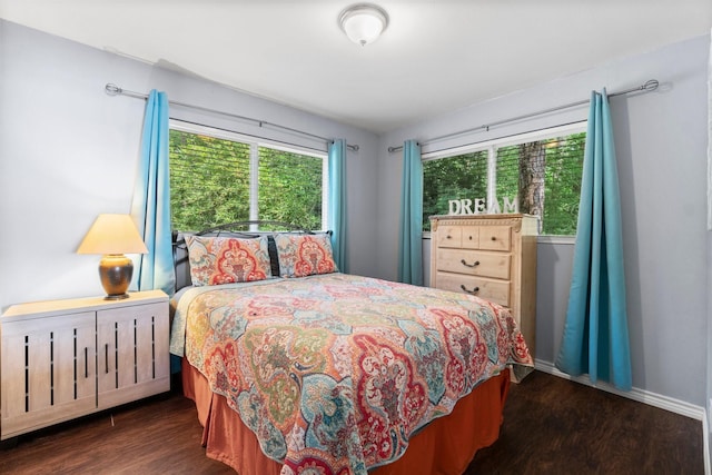 bedroom with wood finished floors and baseboards