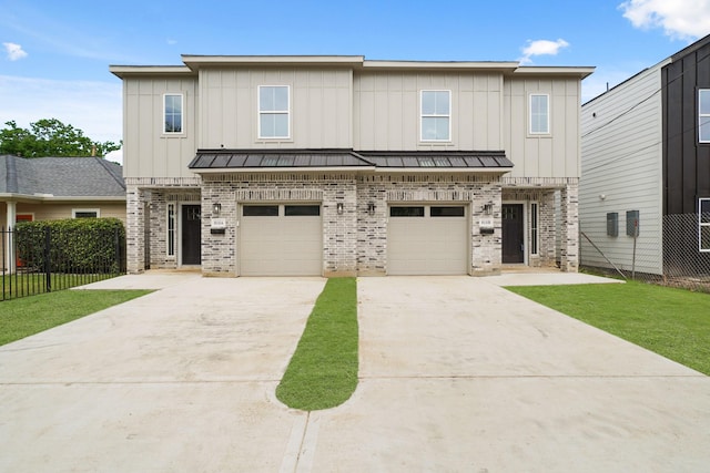 8131 Woodward St, Houston, TX 77051 - view of front facade with brick siding, concrete driveway, board and batten siding, and a garage