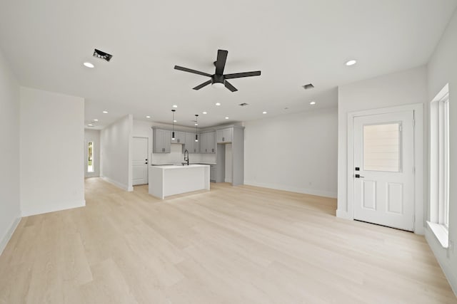 8131 Woodward St, Houston, TX 77051 - unfurnished living room featuring a ceiling fan, recessed lighting, and light wood-style flooring