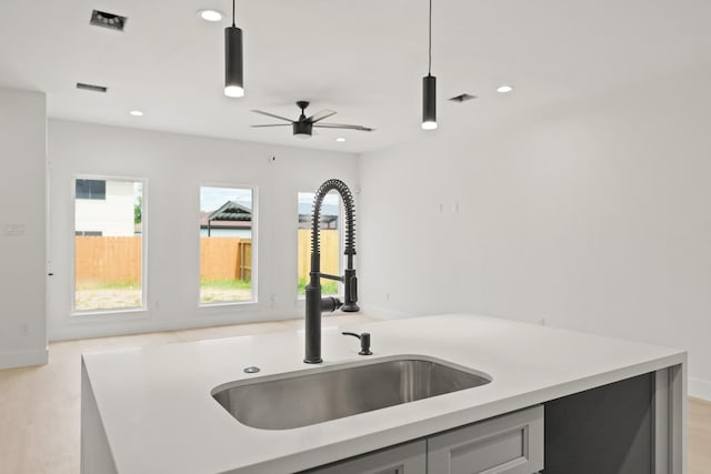 8131 Woodward St, Houston, TX 77051 - kitchen with light countertops, decorative light fixtures, recessed lighting, ceiling fan, and gray cabinetry