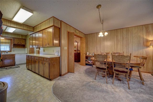 dining area featuring light floors, wood walls, a textured ceiling, and a notable chandelier