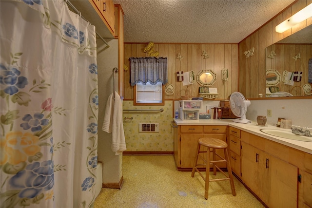 full bathroom with vanity, a textured ceiling, visible vents, and curtained shower