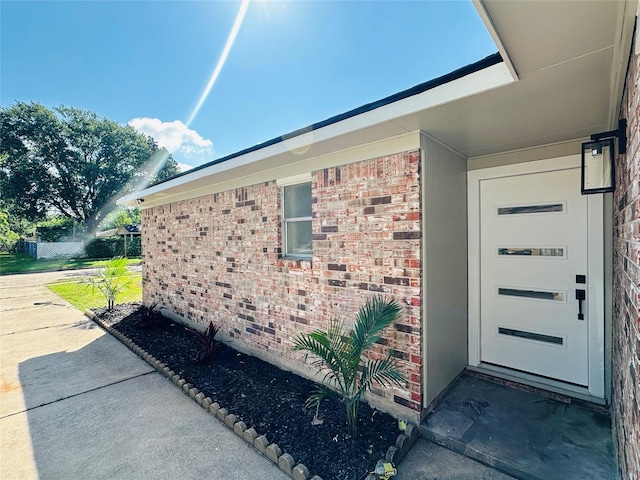 view of side of home featuring brick siding