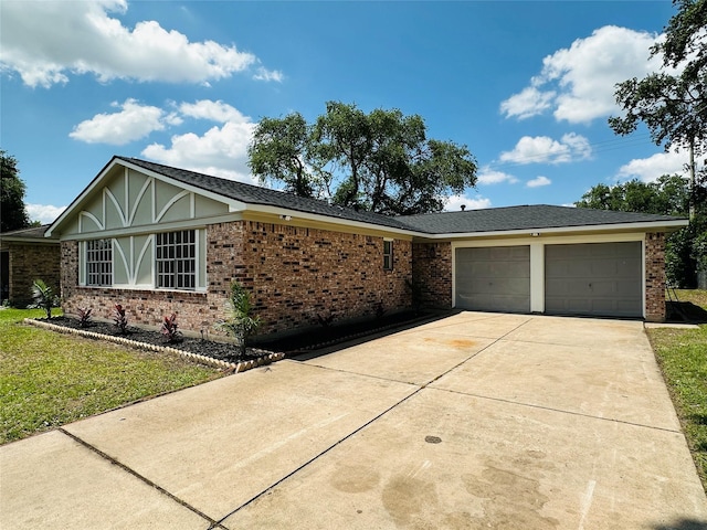 view of front facade featuring a garage, concrete driveway, brick siding, and a front yard