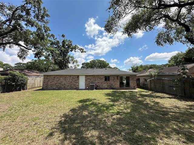rear view of property with central air condition unit and brick siding