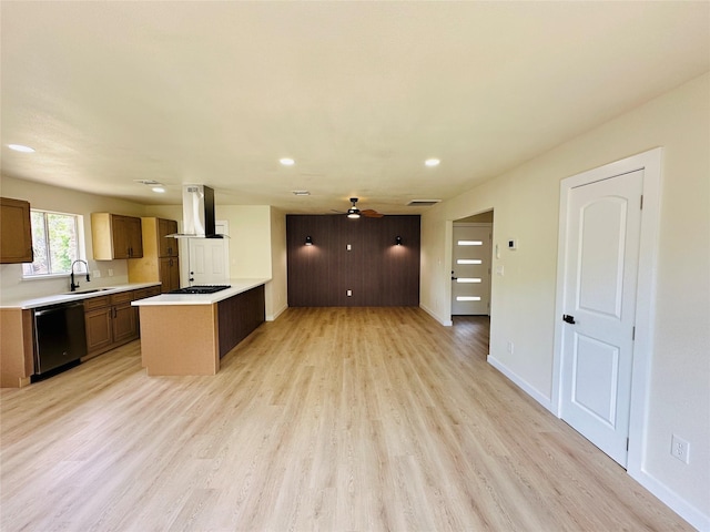 kitchen with dishwashing machine, a sink, island range hood, gas cooktop, and light countertops