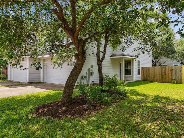 obstructed view of property featuring a front lawn, a garage, concrete driveway, and fence