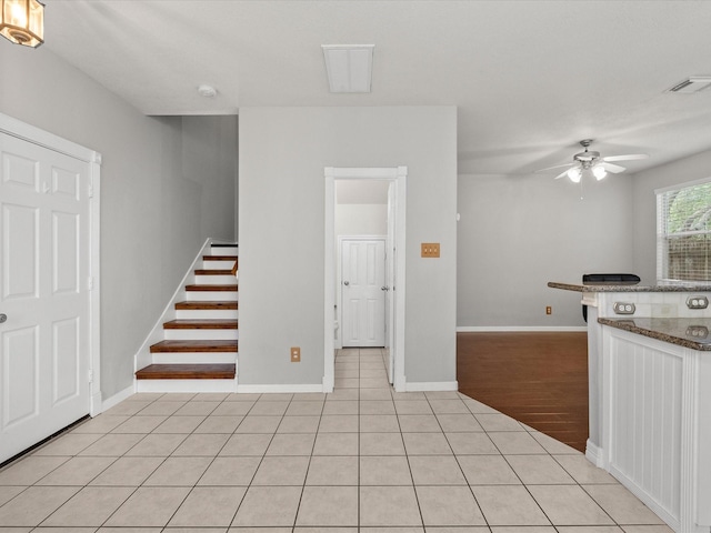 kitchen with visible vents, baseboards, ceiling fan, and light tile patterned floors