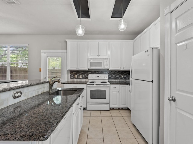 kitchen featuring white appliances, a sink, white cabinetry, and tasteful backsplash