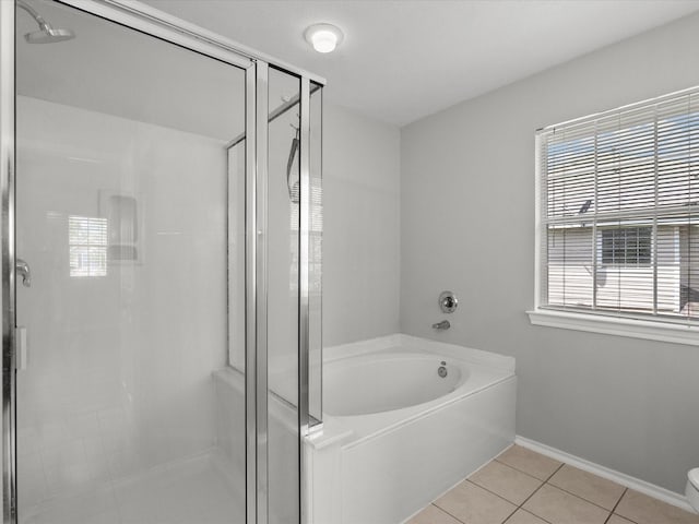 full bath featuring a shower stall, toilet, a bath, baseboards, and tile patterned flooring