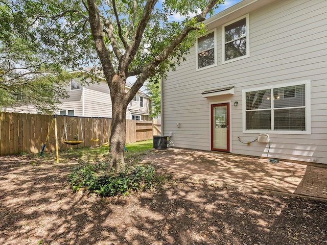 back of house with fence, central AC, and a patio